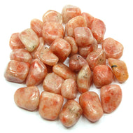A collection of polished red sunstone tumbled gemstones.